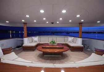 Cream sofas on deck of motor yacht Aspen Alternative as dusk sets
