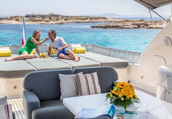 guests sunbathe on sunpads on top deck of motor yacht ‘Cento by Excalibur’ 