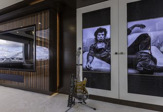 Keith Richard doors, guitar and large TV in the skylounge of luxury yacht King Baby 