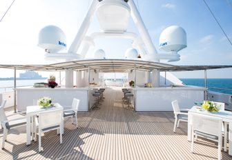 table and chairs and shaded bar under the radar arch on sundeck of motor yacht ‘Moonlight II’ 