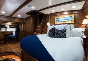bed in walnut-clad master suite aboard luxury yacht MARAE