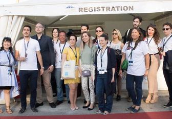 industry professionals pose for a photo at the East Med Yacht Show in Piraeus, Greece