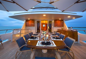 A large dining table on the sundeck of luxury yacht Lady J
