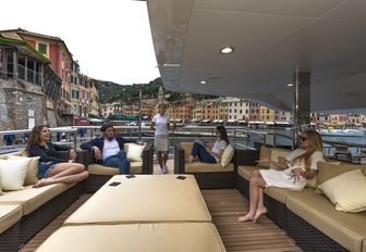 charter guests get together in alfresco seating area on board motor yacht ‘The Wellesley’