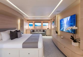 master suite with bed facing large TV on board motor yacht G3