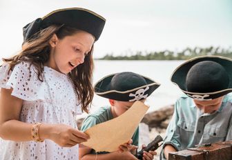 children dressed as pirates find a map