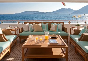 outdoor seating area made up of teak furniture on board motor yacht Ramble on Rose 