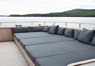 grey upholstered sunpads on the upper deck aft of luxury yacht RH3 