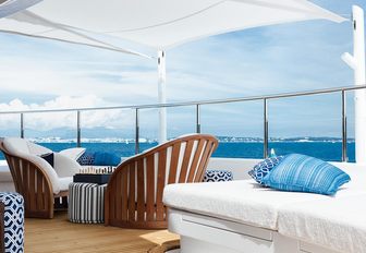 helipad converted into entertainment area with tables, chairs and sunbeds on board motor yacht Cloud 9