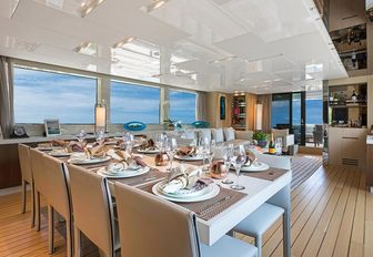 the sumptuous and bright dining area of motoryacht freddy overlooking the caribbean