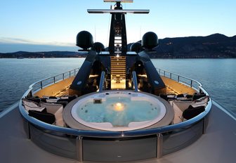 Jacuzzi on the foredeck of luxury yacht OKTO lights up at night