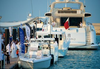 yachts lined up along the busy boardwalks at the Qatar International Boat Show