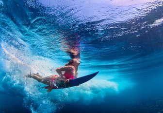 A female surfer seen from underwater