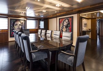 dark wooden dining table in the main salon of luxury yacht RARITY