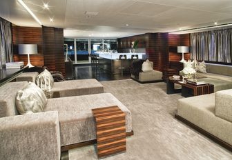 seating area and bar in a salon aboard motor yacht Inception