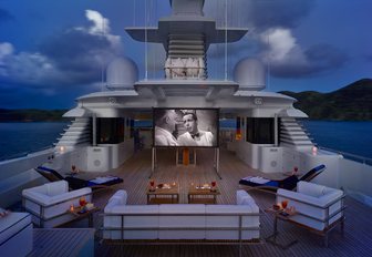 Outdoor cinema set up on sun deck of luxury yacht Victoria del Mar at twilight