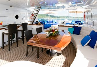 dining table and bar under cover on sundeck aboard Talisman Maiton