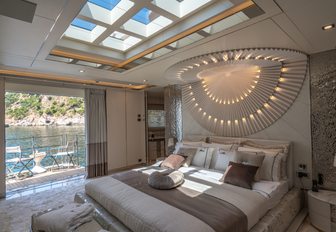 Owner's cabin on superyacht LILUM, with side-opening balconies and skylight in ceiling