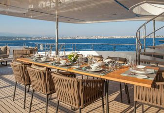 al fresco dining area on the upper deck aft of luxury yacht Big Sky 