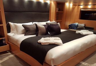 double bed in the master suite with anigre wood panelling on board luxury yacht AWOL