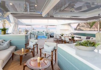 expansive sundeck with bar, seating areas and Jacuzzi on board charter yacht ‘King Baby’ 