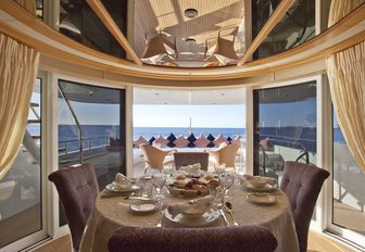 table set for dinner in circular conservatory aboard motor yacht ‘Big Change II’ 
