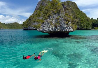 charter guests aboard superyacht LAMIMA go snorkelling when on a luxury yacht charter in Indonesia