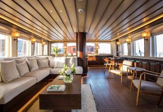 L-shaped sofa and armchairs in the main salon of luxury yacht SATORI