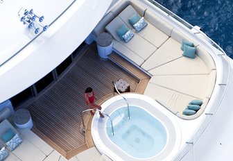 A charter guest enjoys the Jacuzzi on the sundeck of M/Y 'Lady Britt'