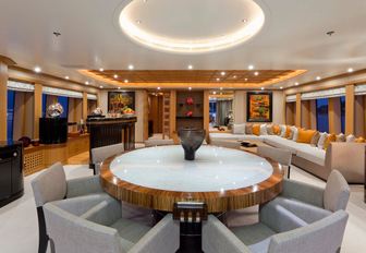 circular dining table and L-shaped sofa in skylounge on board charter yacht HANIKON 