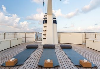 yoga mats line up on the upper level of the sundeck aboard luxury yacht PIONEER