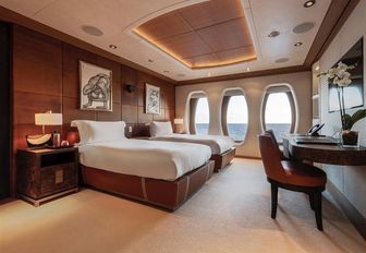 Large cabin with double bed and oval shaped windows on Superyacht SUNRAYS