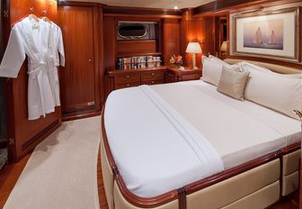 full-beam master suite with rich woodwork and large bed aboard luxury yacht HYPERION