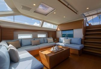 Main salon of luxury sailing yacht FARFALLA, with wide windows and seating area