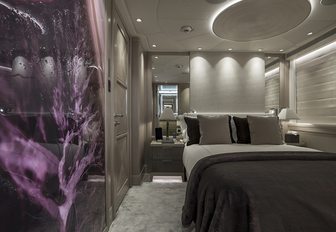 Guest accommodation on board superyacht IRISHA, with gemstone panels and grey plush carpets