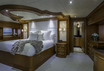 large bed with white linen in the master suite aboard charter yacht M3