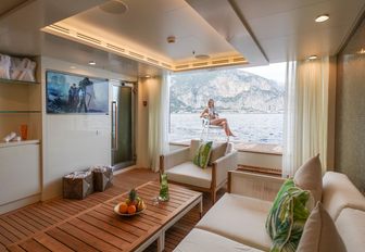 teak-clad beach club on board charter yacht Quinta Essentia with view out onto swim platform