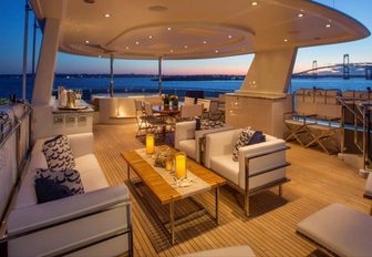 open-air lounge, bar, dining table and jacuzzi on the sundeck of motor yacht Far Niente