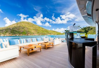 main deck aft aboard motor yacht Party Girl with lounging area and bar