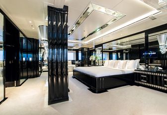 Full-beam master suite with mirrored walls and cream furnishings on superyacht silver angel