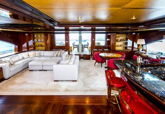 the luxurious and stylish upper lounge of crewed yacht BASH featuring an intimate seating arangement and indoor cocktail bar