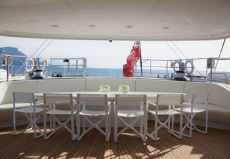 Alfresco dining with white furniture on board luxury yachts Panthalassa