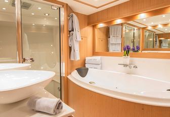 his-and-hers sinks, bath tub and shower in master suite's en-suite aboard charter yacht EMOJI 