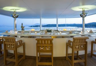 large bar with stools on the deck of motor yacht Coral Ocean