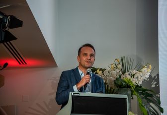 man speaking giving a talk at the Monaco Yacht Show 2022