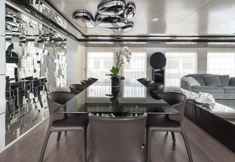 glass dining table in main salon of luxury yacht ENTOURAGE 