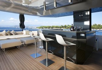 sleek bar and lounging area on upper deck of charter yacht JURATA 