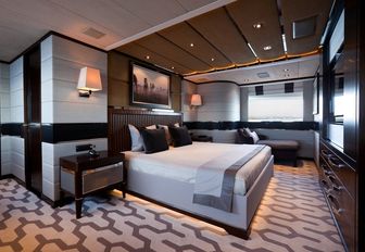 full-beam master suite with carpets inspired by tyre treads on board charter yacht AURELIA