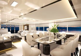 dining table and lounge in the main salon of charter yacht O’Mathilde 