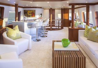 seating space and bar on luxury motor yacht at last